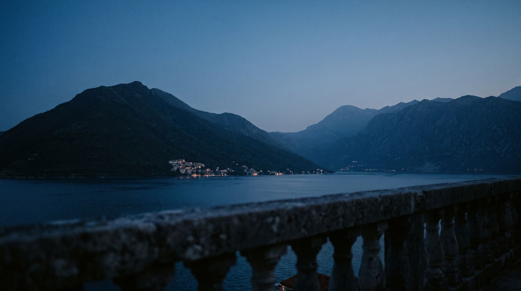 The Bay of Kotor at dusk, seen from a stone terrace