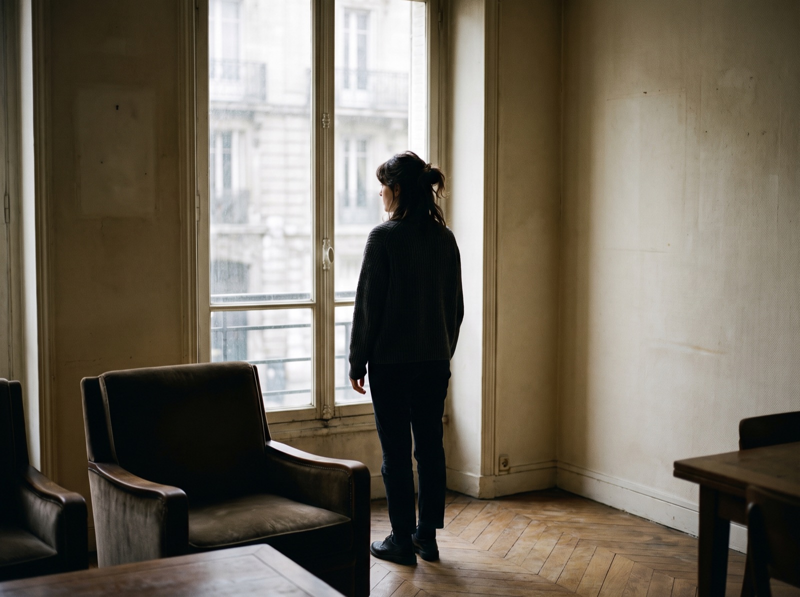 A woman at a window in a historic apartment